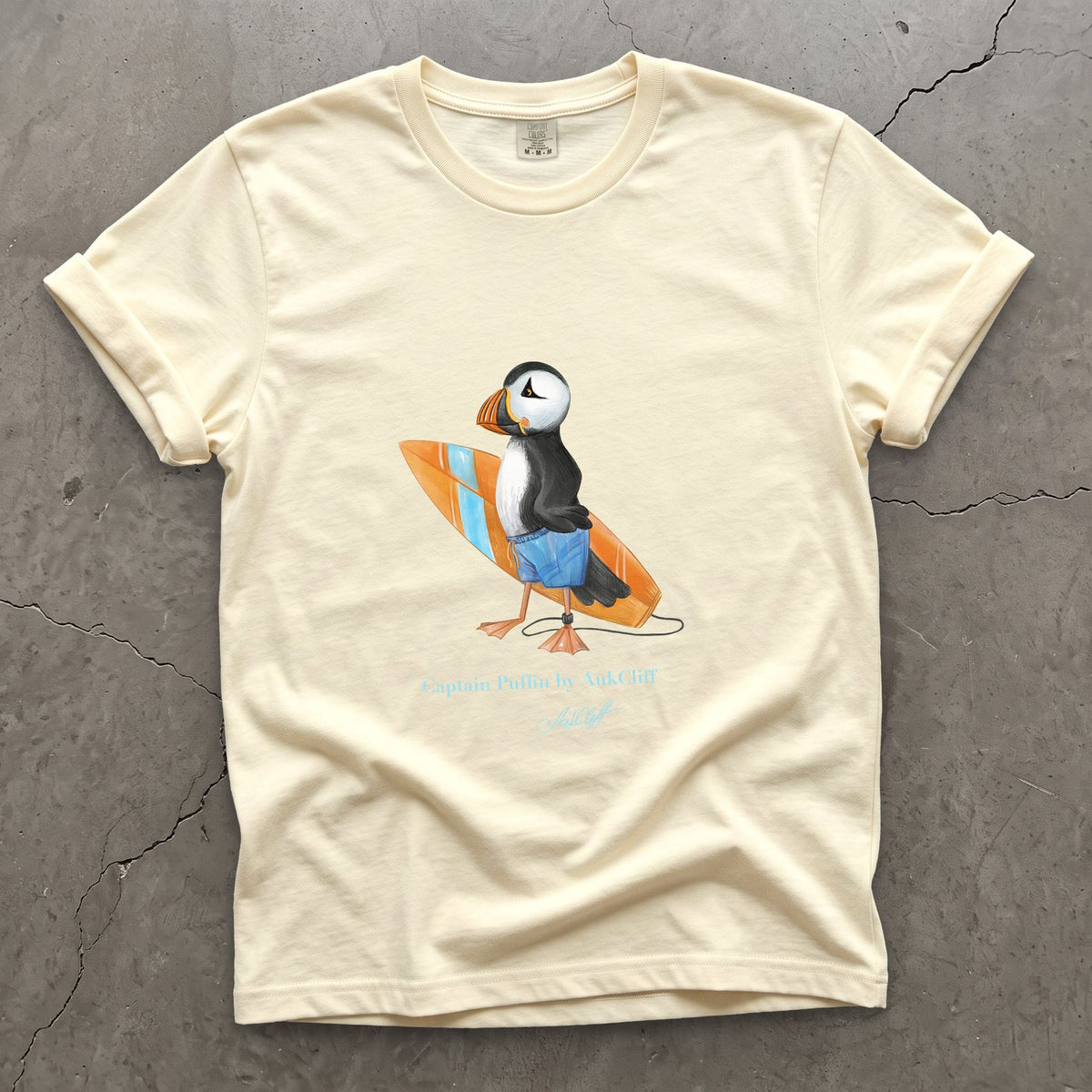 Captain Puffin Surfer on a Ivory Comfort Colors t-shirt