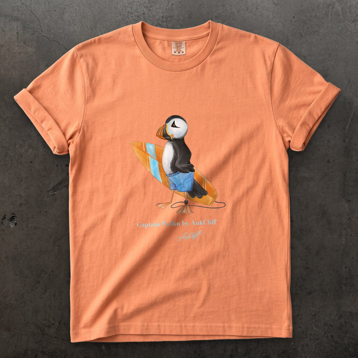 Captain Puffin Surfer on a Terracotta Comfort Colors t-shirt