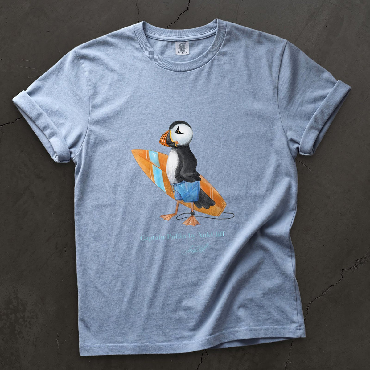 Captain Puffin Surfer on a Washed Denim Comfort Colors t-shirt