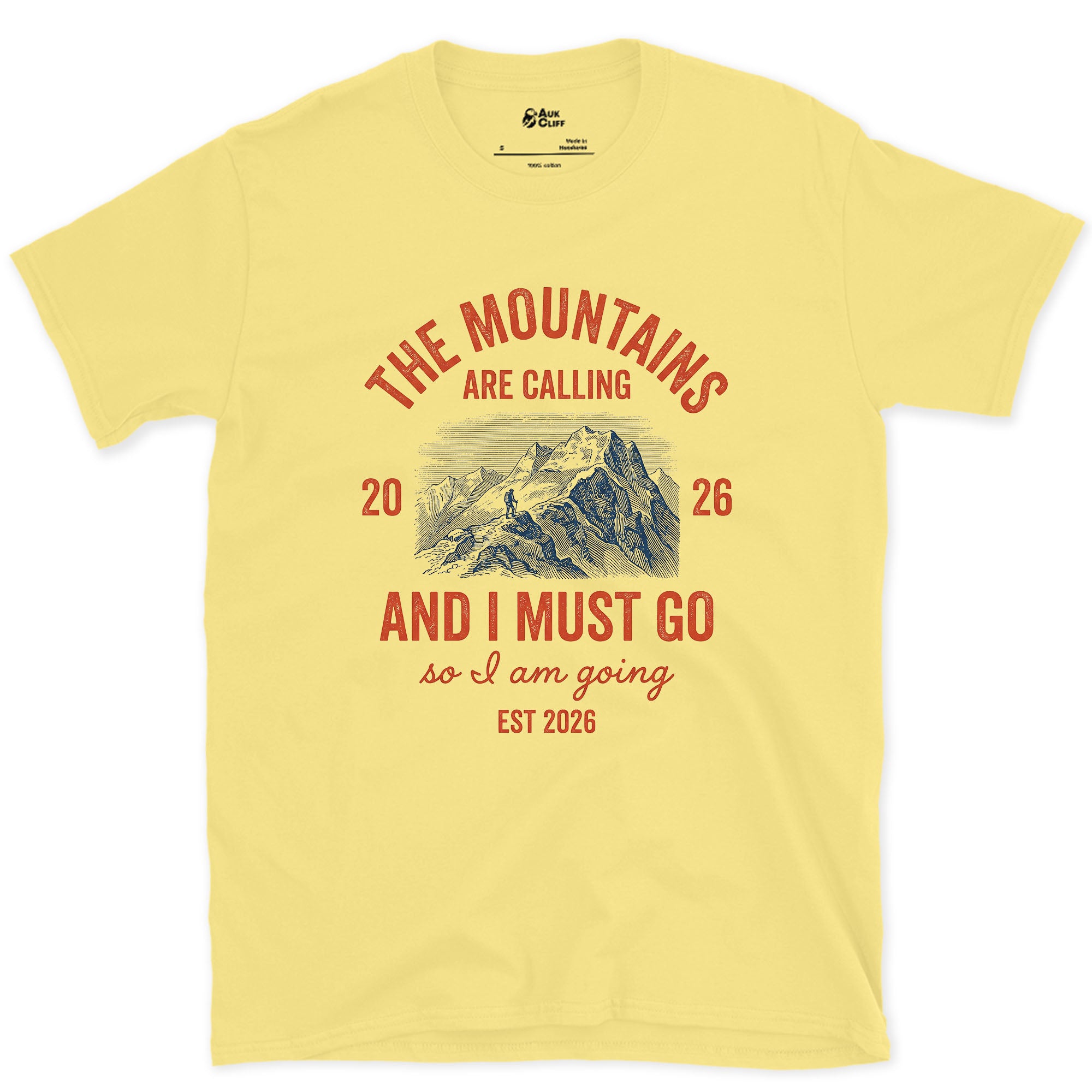 The Mountains Are Calling, So I Am Going design on a Cornsilk Gildan Softstyle t-shirt