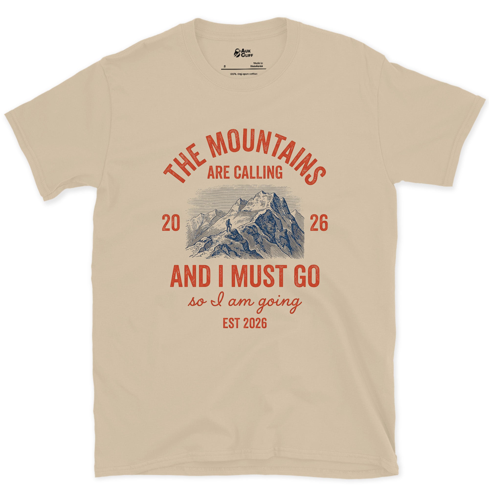 The Mountains Are Calling, So I Am Going design on a Sand Gildan Softstyle t-shirt