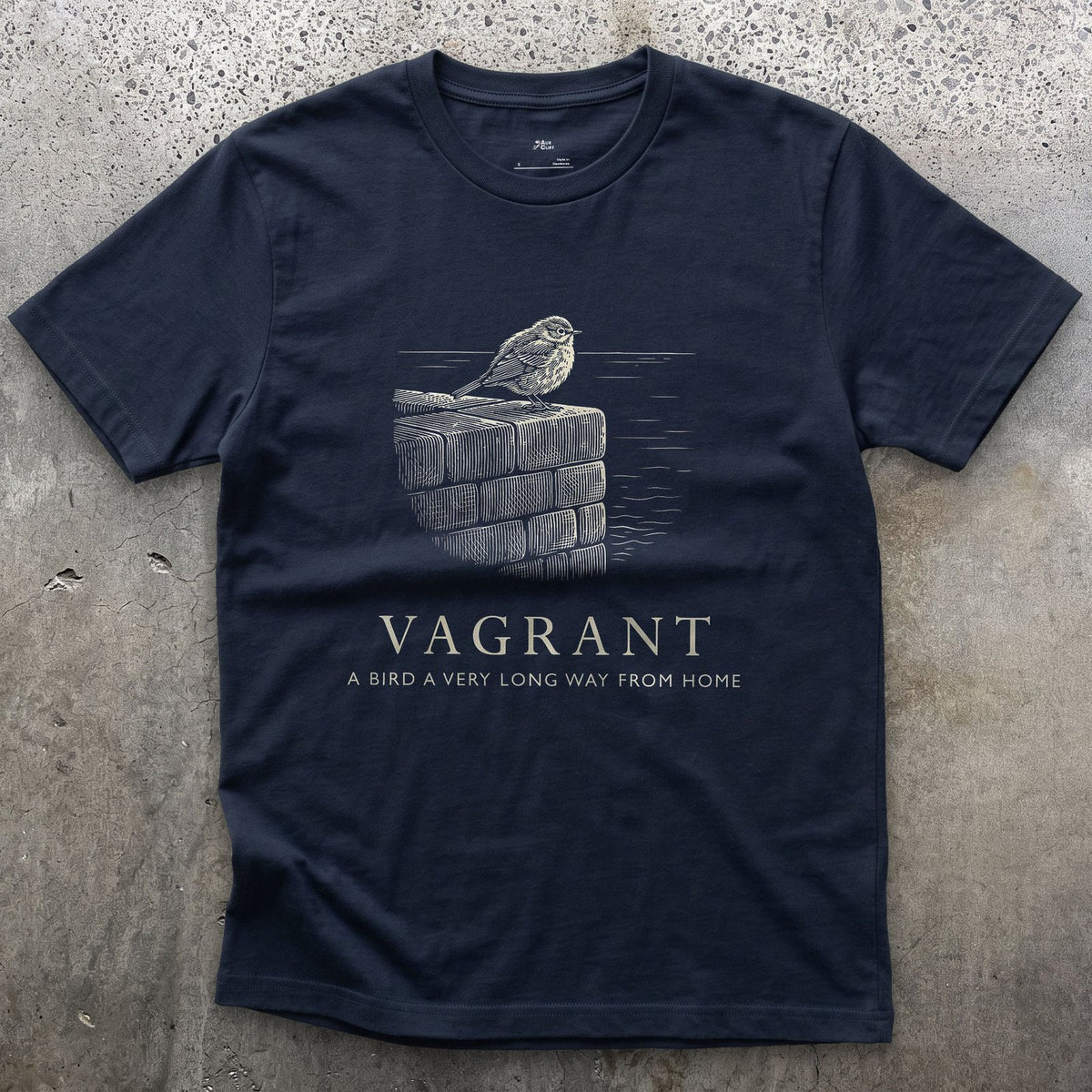 Vagrant, a Bird a Very Long Way From Home design on a Navy Gildan Softstyle t-shirt