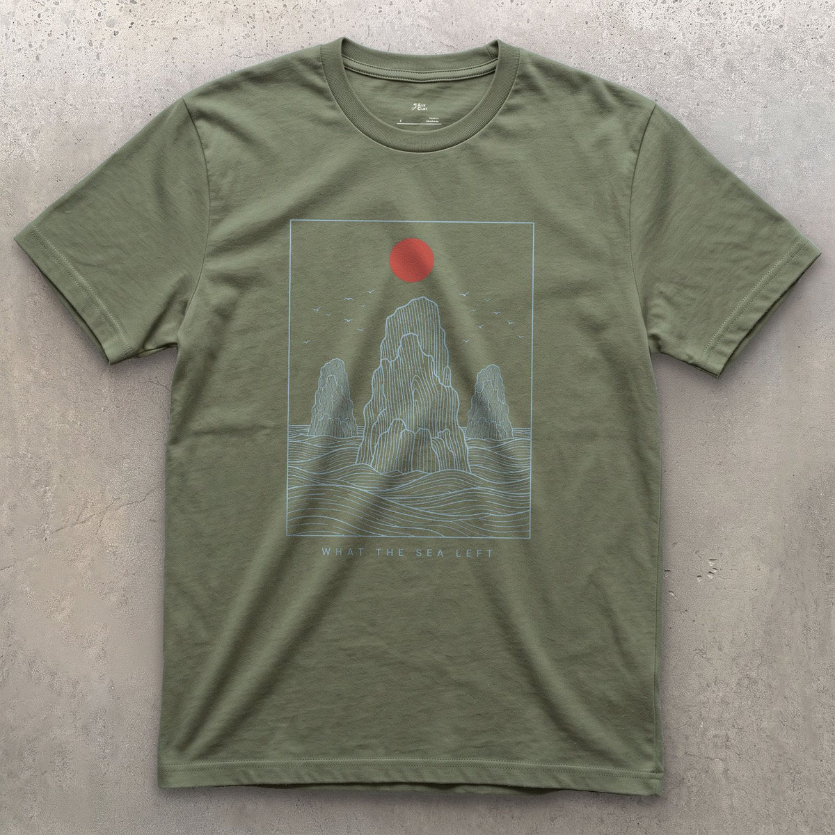 What the Sea Left, Stacks and Birds design on a Military Green Gildan Softstyle t-shirt
