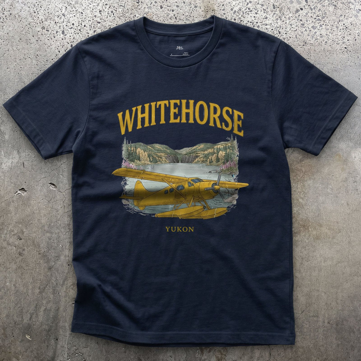 Whitehorse Bush Plane design on a Navy Gildan Softstyle t-shirt