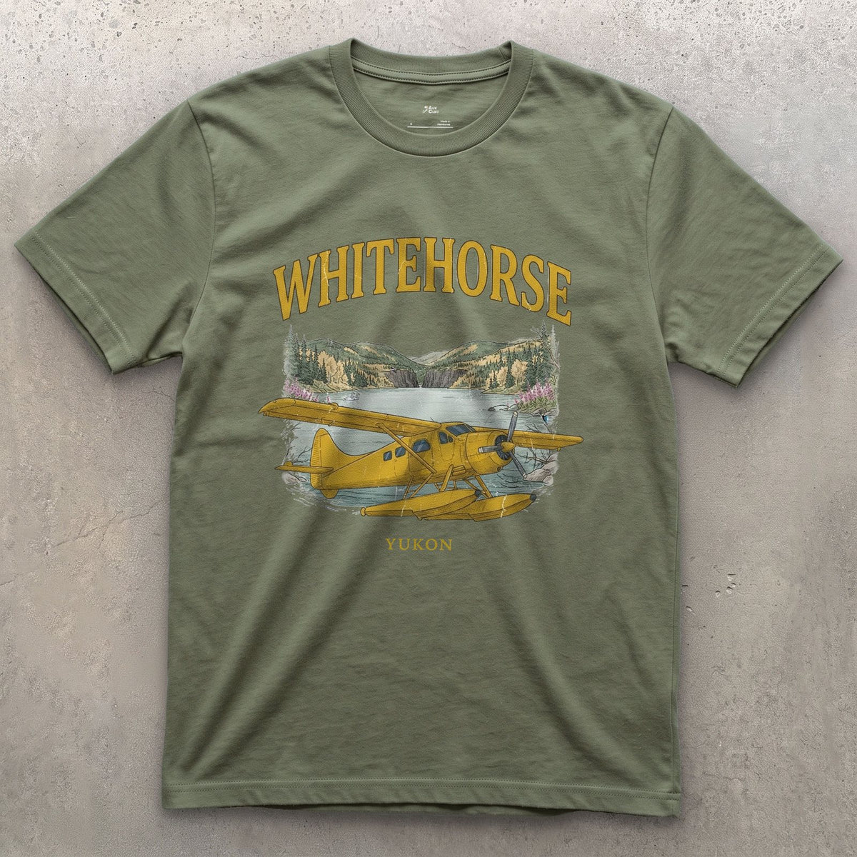 Whitehorse Bush Plane design on a Military Green Gildan Softstyle t-shirt