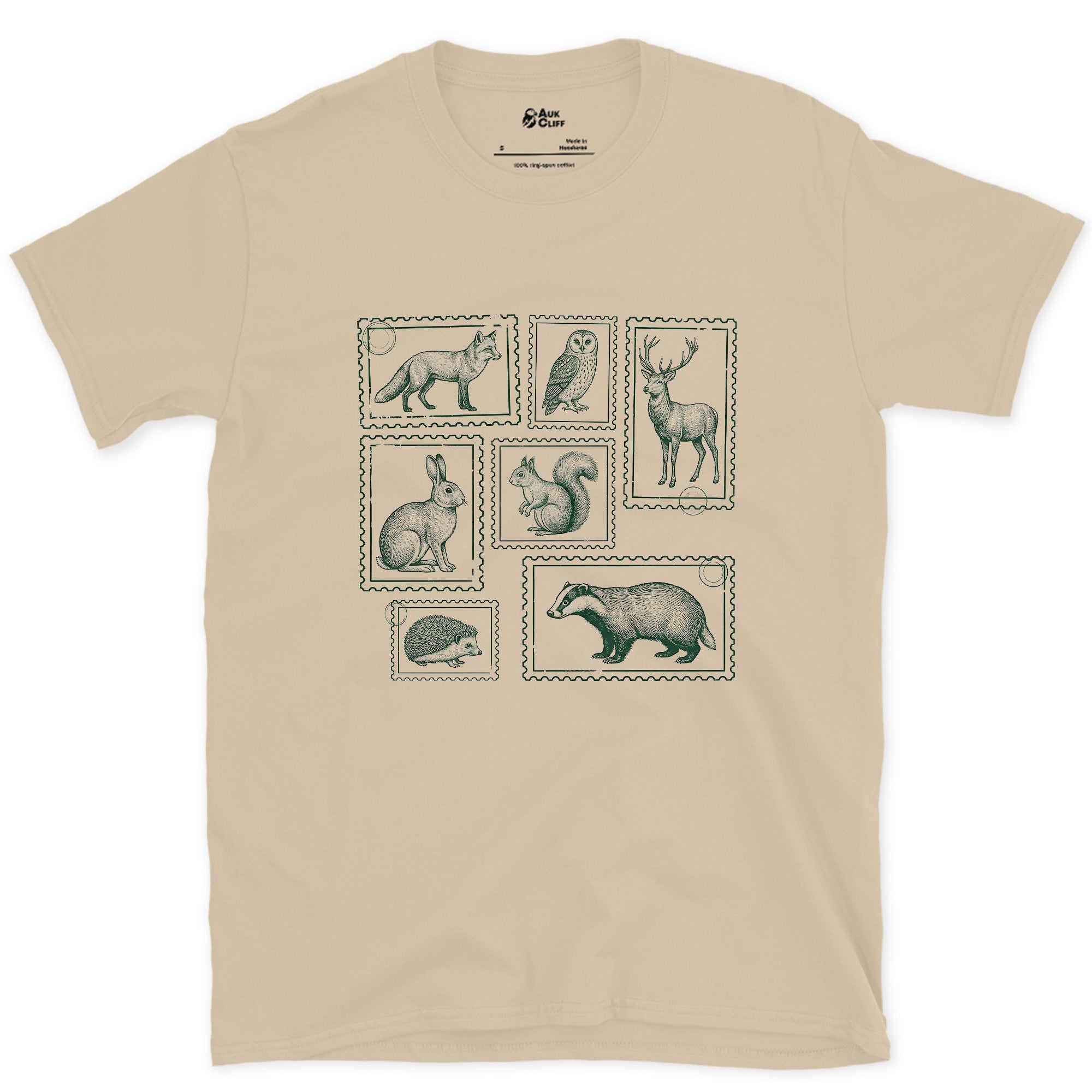 The Whole Woodland Framed Like Stamps design on a Sand Gildan Softstyle t-shirt