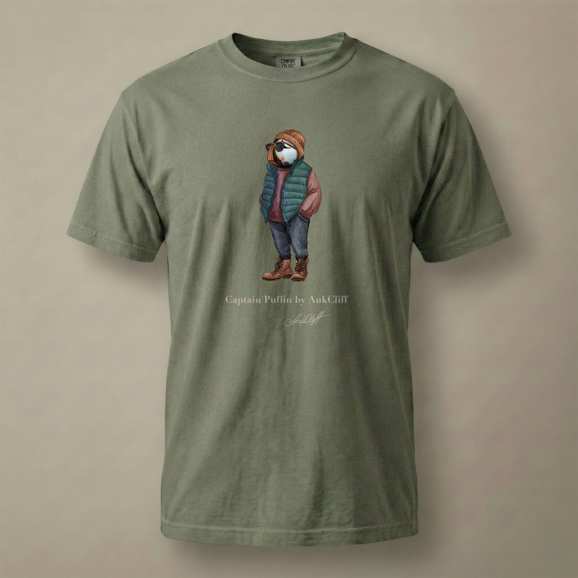 AukCliff® Captain Puffin T-shirt Moss / S Captain Puffin™ “Puffer Vest Nomad” Comfort Colors T-Shirt