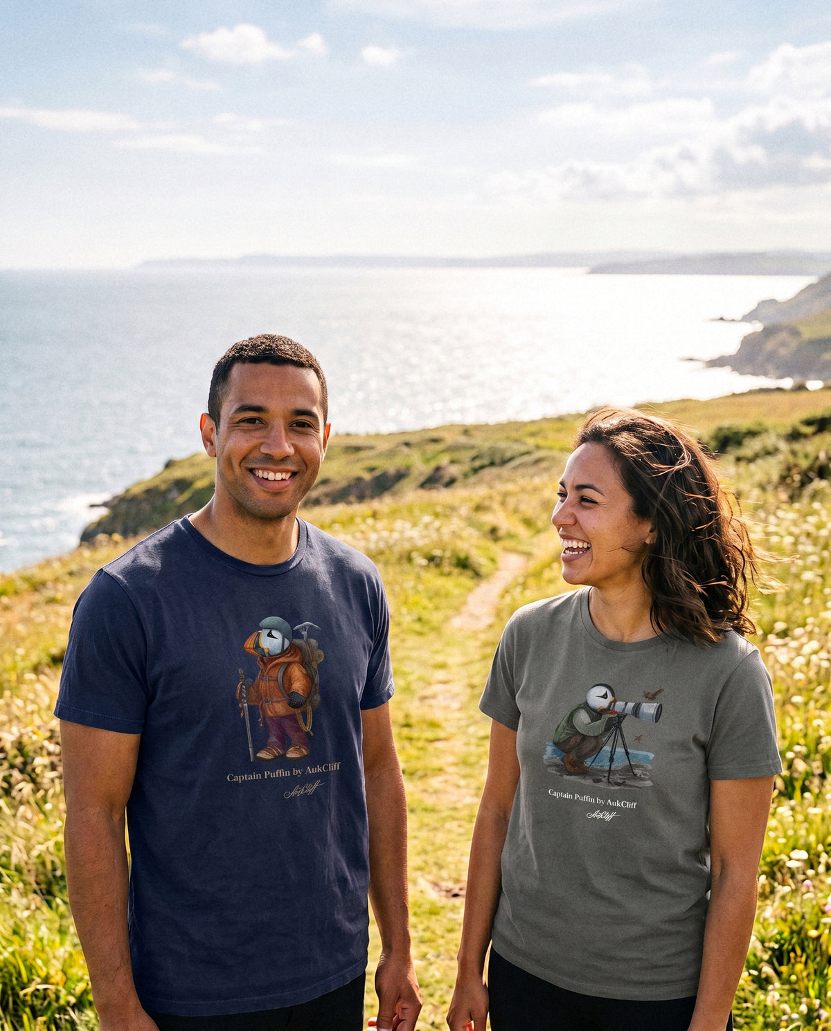 Two people wearing Captain Puffin tees on a headland